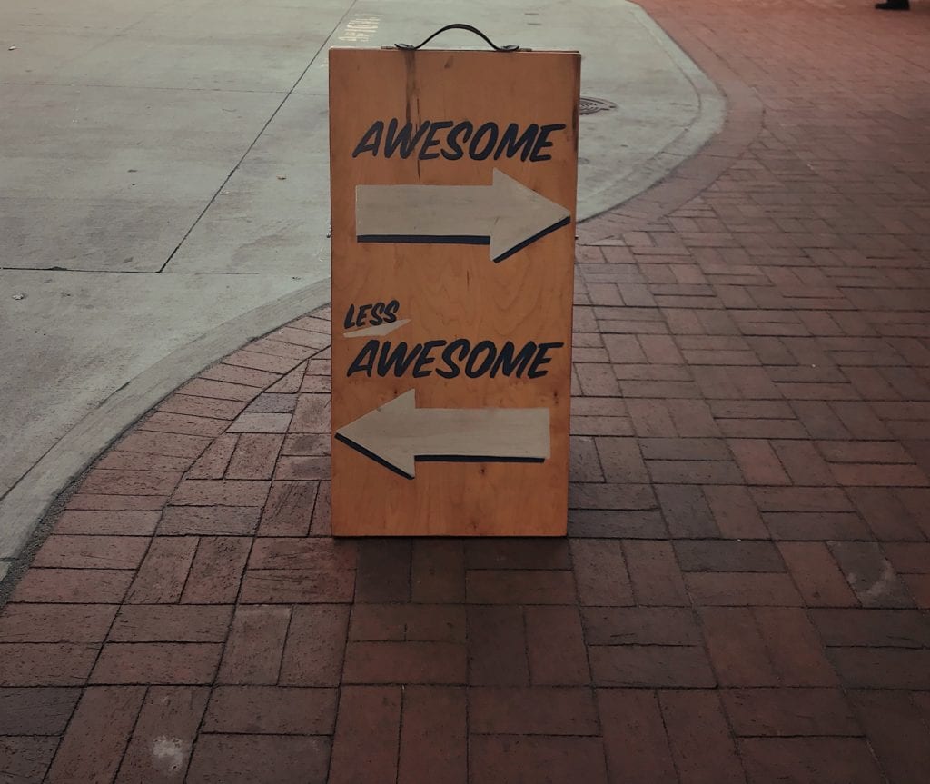 sandwich board saying Awesome, less awesome