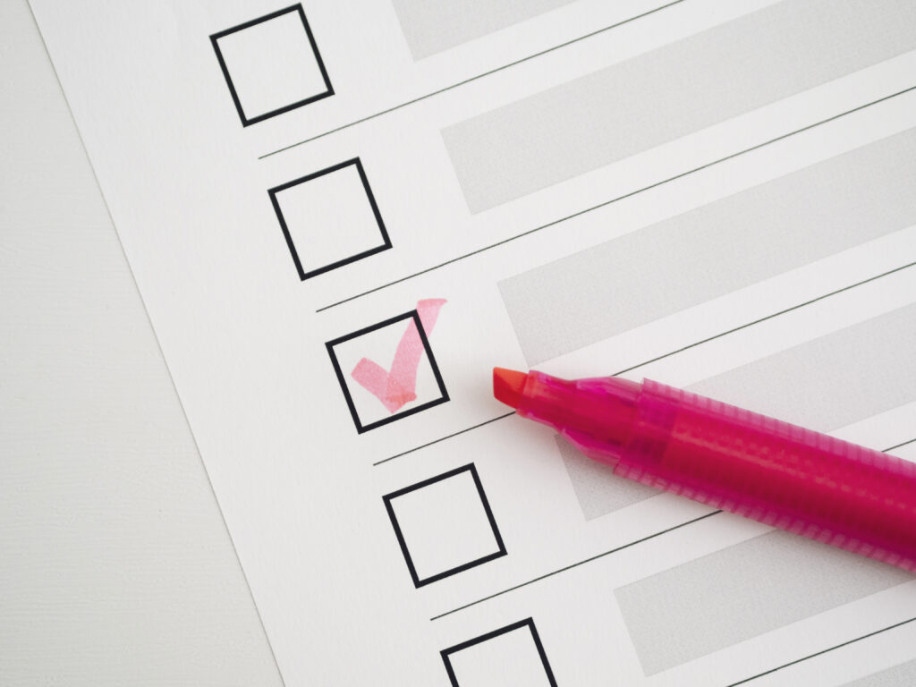 Checklist with one box ticked in pink marker, symbolising progress or completed actions.